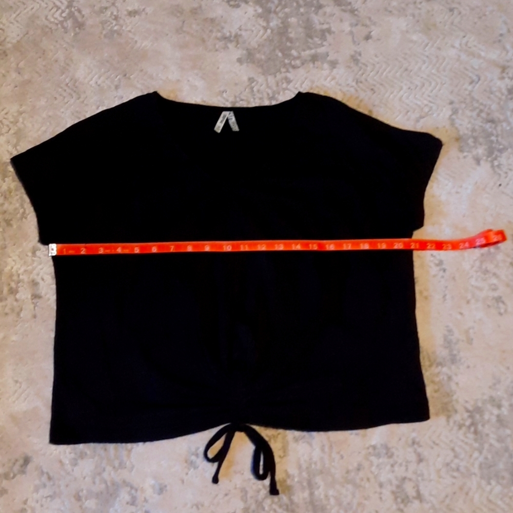 Black short sleeve top with cinch front tie.